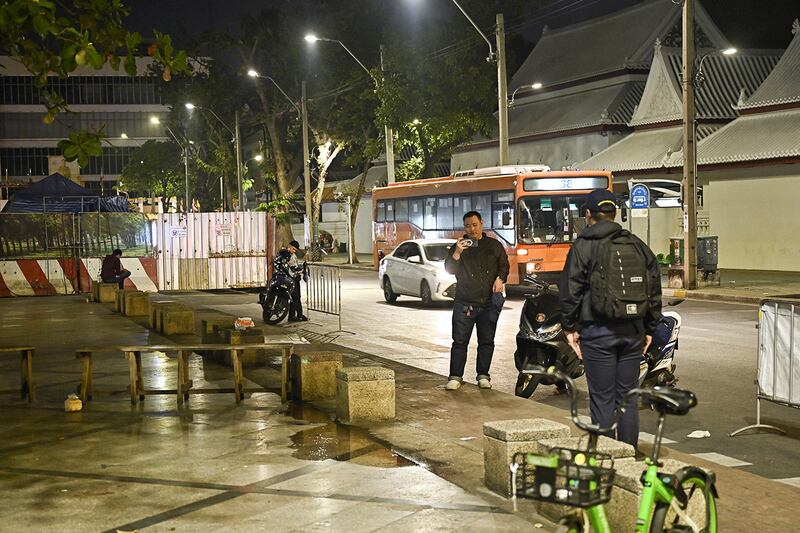 Central Investigation Bureau members stand near the spot where Lim Kimya, a former Cambodian MP, was shot in Bangkok on Jan. 7, 2025.