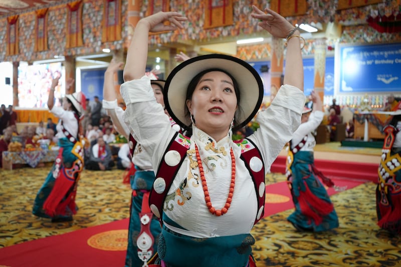 A dance is performed as Tibetan spiritual leader the Dalai Lama, seated rear right, at the Main Temple in Dharamsala, India, on June 30, 2025, as celebrations begin in the days leading up to his 90th birthday on July 6.