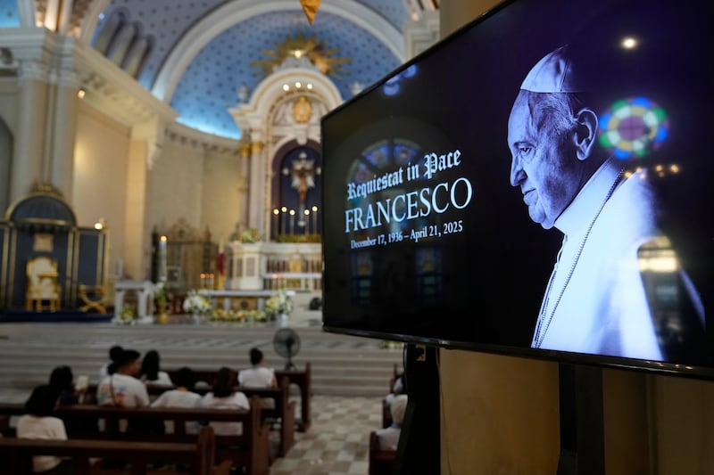 An image of the late Pope Francis is shown as devotees pray at a church in Quezon city, Philippines, April 21, 2025.