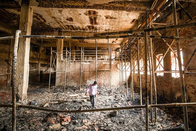 A man walks inside a burnt studio of the state-owned Bangladesh Television in Dhaka, Bangladesh, July 24, 2024. (Rajib Dhar/AP)