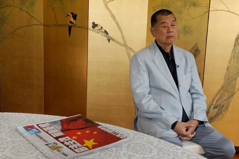 Hong Kong media tycoon Jimmy Lai and a copy of Apple Daily's July 1, 2020, edition during an interview Hong Kong, July 1, 2020.
